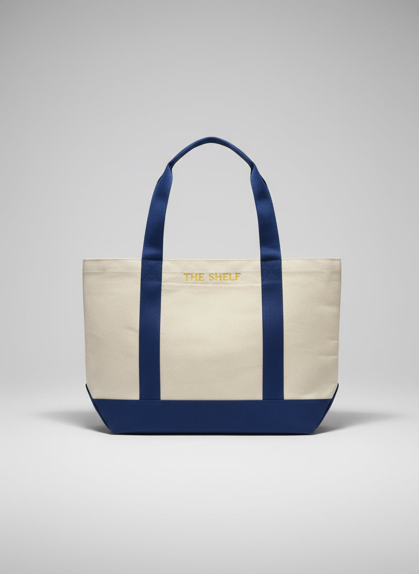 Tote bag with royal blue handles and trim on a light gray background