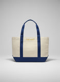Tote bag with royal blue handles and trim on a light gray background